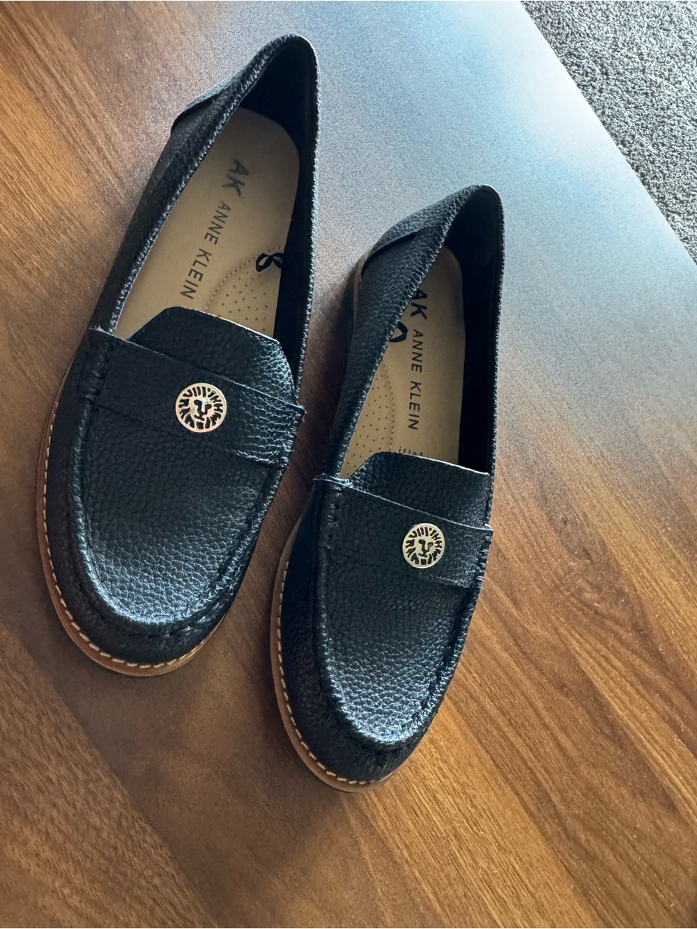Anne Klein Black Pebbled Leather Penny Loafers with Gold Emblem